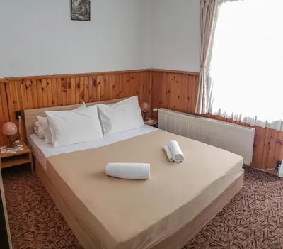 a bedroom with a bed with two towels on it at Guest Rooms- KLEPALSKI House in Borovets