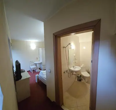 a bathroom with a sink and a shower and a toilet at Guest House ANEX in Bansko