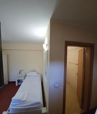 a hospital room with a bed and a hallway at Guest House ANEX in Bansko