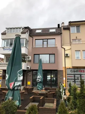 two green umbrellas sitting in front of a building at При Павката (Pri Pavkata) in Samokov
