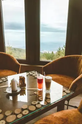 a table with two drinks on it with two chairs at Hotel and Relax Moreni in Sofia