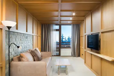 a living room with a couch and a tv at Hotel and Relax Moreni in Sofia