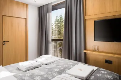 a hotel room with a bed with towels on it at Hotel and Relax Moreni in Sofia