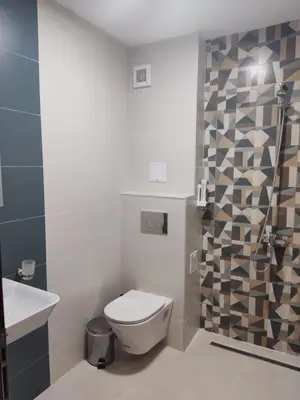 a bathroom with a toilet and a sink at Sapareva Apartments in Sapareva Banya