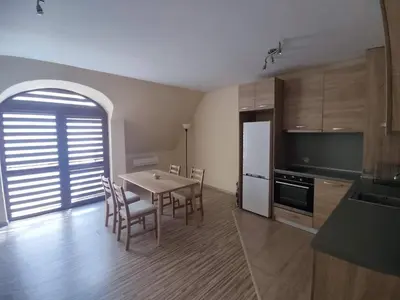 a kitchen and dining room with a table and chairs at Sapareva Apartments in Sapareva Banya