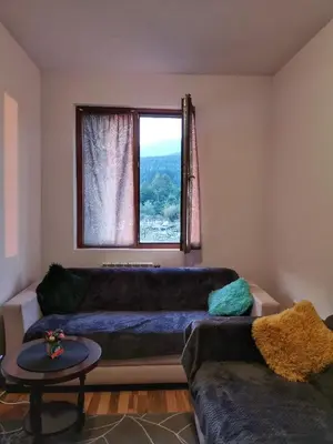 a living room with a couch and a window at Double Studio near SKI Lift - Bansko in Bansko