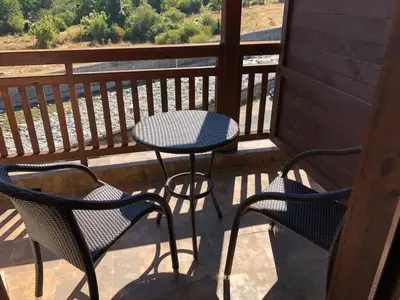 two chairs and a table on a balcony with a view at Mountain View Apartment in Bansko