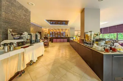 a restaurant with a buffet line in a room at Sana Spa Hotel in Hisarya
