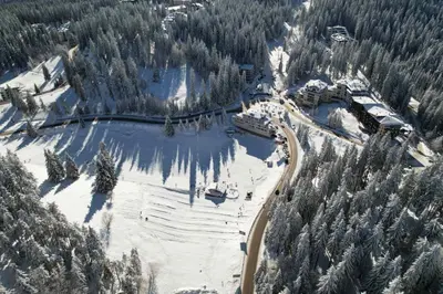 an aerial view of a ski resort in the snow at Апартамент Pamporovo Palace in Pamporovo