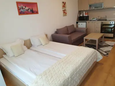 a large bed in a living room with a couch at Private Studio in Aspen Golf and Ski Resort in Razlog