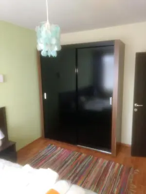 a living room with a sliding glass door with a television at Borovets Apartments, Iglika 2 in Borovets