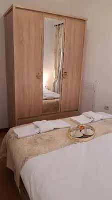 a white bed with a mirror on top of it at Апартамент Winter home Iceberg in Pamporovo