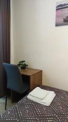 a hotel room with a desk and a bed and a chair at Elitsa Apartment in Pamporovo