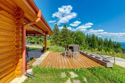 a wooden deck on the side of a house at Вила Морава in Pamporovo