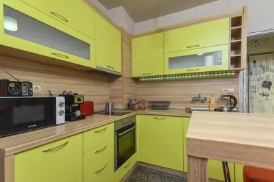 a kitchen with lime green cabinets and a microwave at Vintage Spot - Colorful One-Bedroom Apartment by Flat Mаnager in Sofia