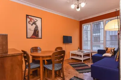 a living room with a table and a blue couch at Vintage Spot - Colorful One-Bedroom Apartment by Flat Mаnager in Sofia