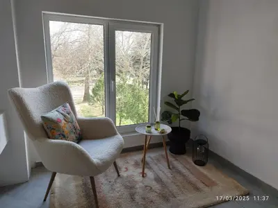 a room with a chair and a table and a window at LUXURY SUITES 3 in Karlovo