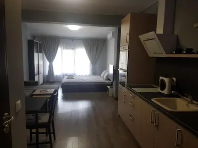 a room with a bed and a kitchen with a sink at LUXURY SUITES 3 in Karlovo