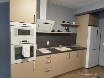 a kitchen with white appliances and a sink at LUXURY SUITES 3 in Karlovo