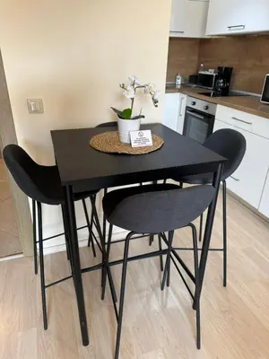 a black table and chairs in a kitchen at Emerald Buddha Apartment in Bansko