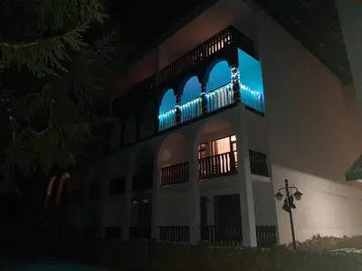 a building with blue lights on it at night at Апартамент КАРЛИН in Pamporovo