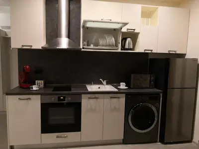 a kitchen with a sink and a washing machine at Apartment Unique in Plovdiv