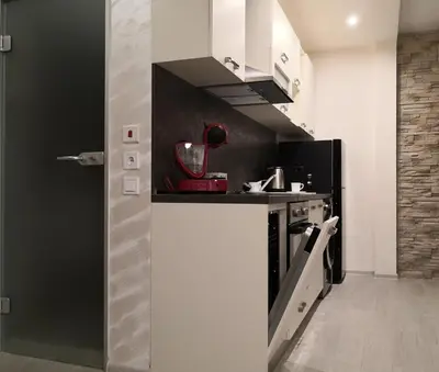 a kitchen with a black and white kitchen at Apartment Unique in Plovdiv