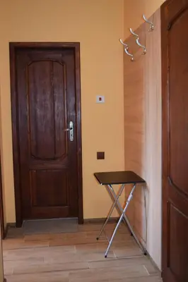 a door and a table in a room with a door at Vesi's Rooms in Plovdiv