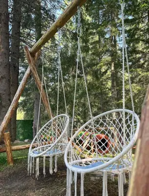 two white chairs hanging from a swing set at Villa Ivan & Petar in Semkovo