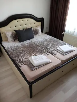 a bed with two towels on top of it at Къща за гости 