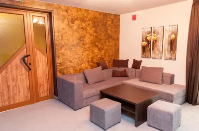 a living room with a couch and a table at Hotel Balkan in Botevgrad
