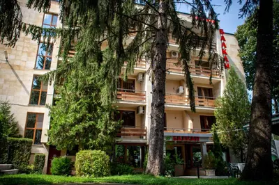 a building with trees in front of it at Hotel Balkan in Botevgrad
