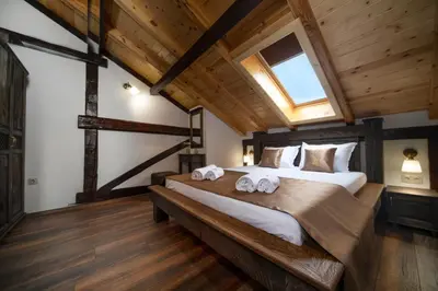 a bedroom with a large bed with towels on it at Hotel Antique - free private parking in Plovdiv