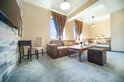 a living room with a couch and a table at Hotel Antique - free private parking in Plovdiv