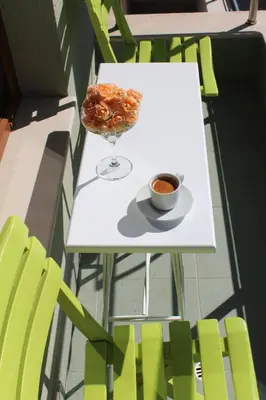 a table with a bowl of food and a cup of coffee at Rebus Apartments in Sandanski