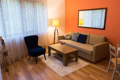 a living room with a couch and a table at Rebus Apartments in Sandanski