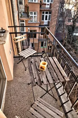 a wooden bench sitting on top of a balcony at 66 in Sofia in Sofia