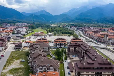 an aerial view of a city with mountains in the background at Neon Luxury apartments next to the Gondola in Bansko