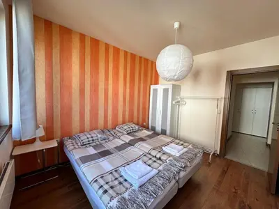 a bedroom with a bed and a pendant light at Neon Luxury apartments next to the Gondola in Bansko
