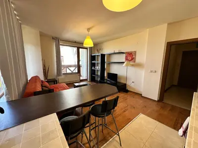 a living room with a large table and chairs at Neon Luxury apartments next to the Gondola in Bansko