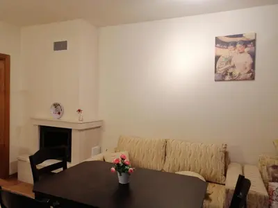 a living room with a table and a couch at Studio at Home Pamporovo in Pamporovo