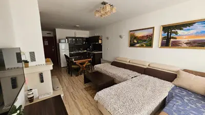 a living room with a couch and a table at Apartament Harmony in Monastery complex in Pamporovo