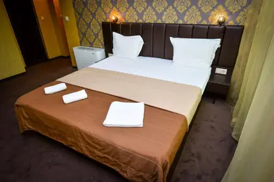 a bedroom with a bed with two white towels on it at Guest house VRAZHDEBNA in Sofia