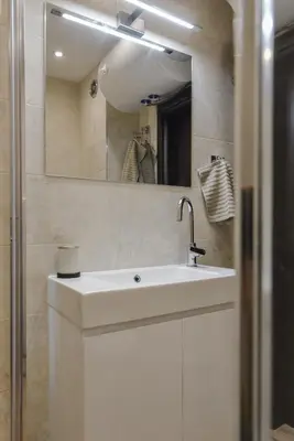 a bathroom with a white sink and a mirror at The Grunge Spot - Charming NEW 1-Bedroom by Flat Mаnager in Sofia