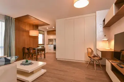 a living room with a couch and a table at The Grunge Spot - Charming NEW 1-Bedroom by Flat Mаnager in Sofia
