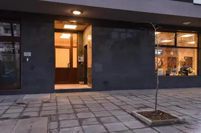 a tree in a courtyard in front of a building at The Grunge Spot - Charming NEW 1-Bedroom by Flat Mаnager in Sofia