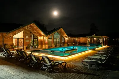 a swimming pool at night with chairs around it at Thermal Camping Velingrad in Velingrad