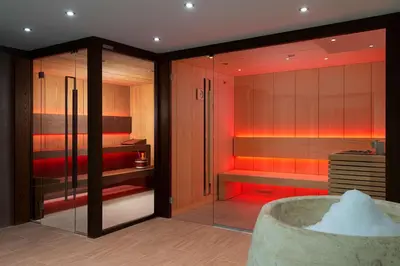 a bathroom with a tub and a bedroom with red lighting at Hyatt Regency Sofia in Sofia