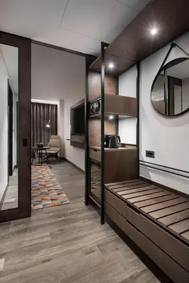 a living room with a large mirror and a kitchen at Hyatt Regency Sofia in Sofia