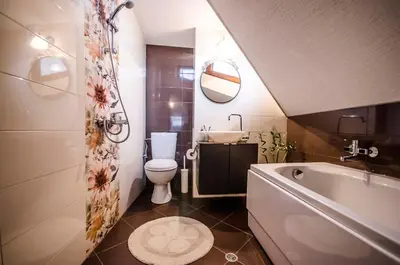 a bathroom with a tub and a toilet and a sink at Off Vitosha Blvd Designer Apart in Sofia